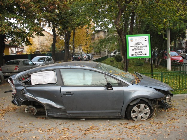 Autowrak naast trots bordje Mogelijk gemaakt door Sector 2